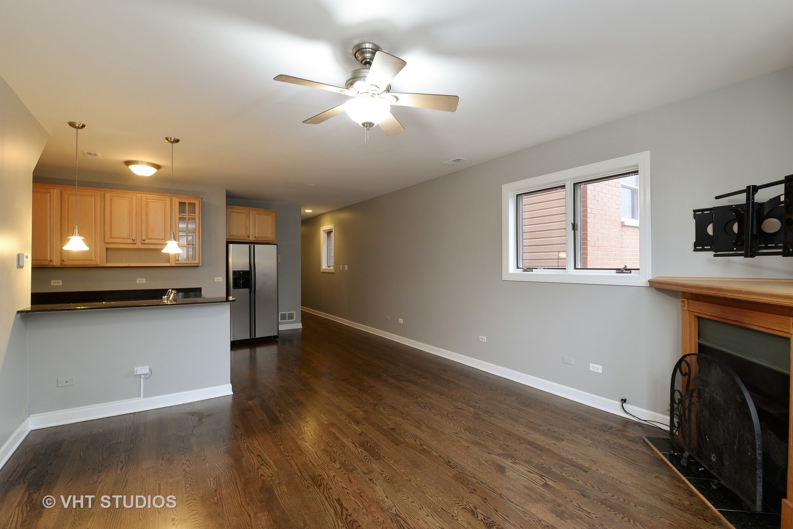 514 South Denvir Avenue, Unit 2 Chicago, IL 60612 - Photo 6 of 13 a view of an empty room with a fireplace and a window