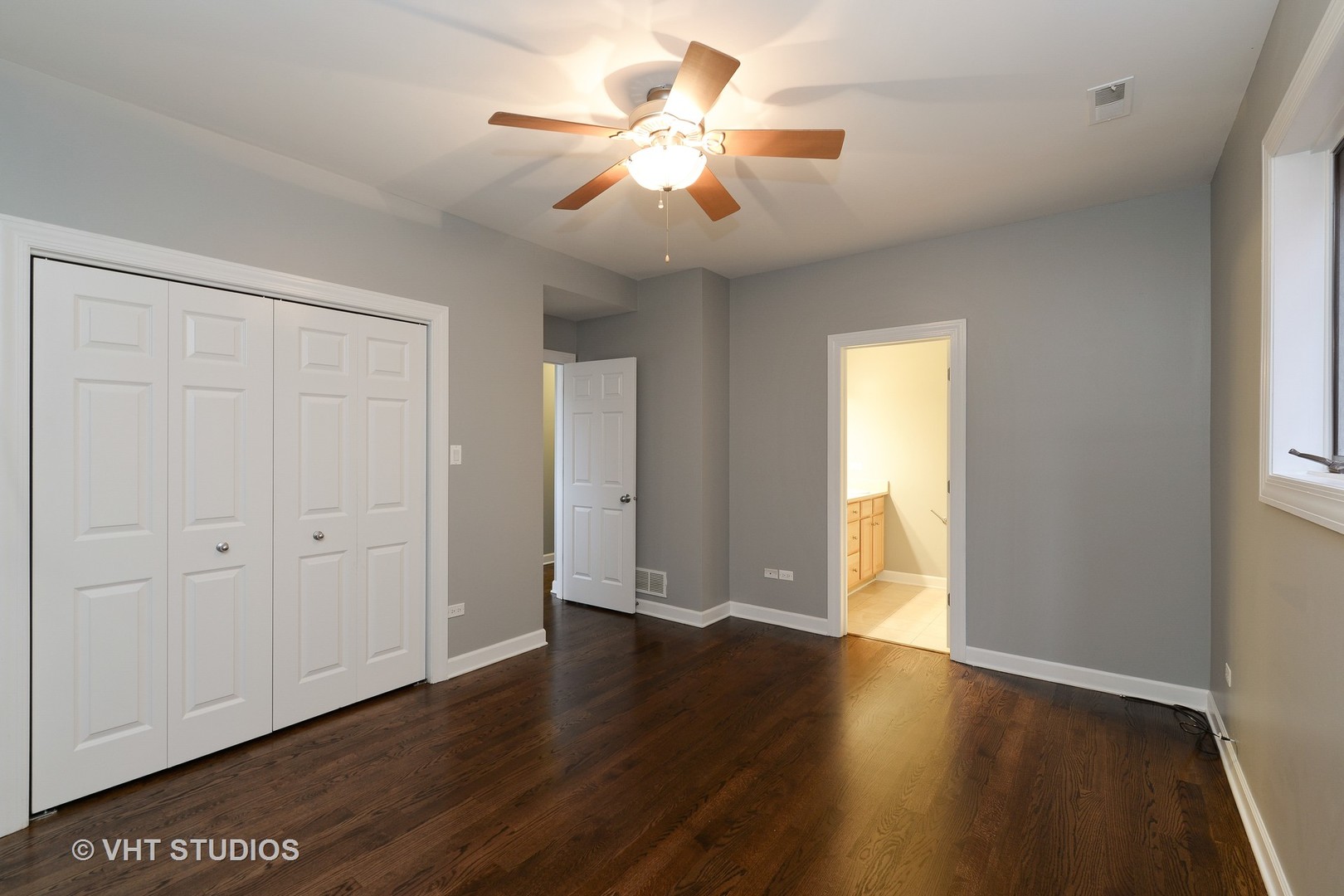 514 South Denvir Avenue, Unit 2 Chicago, IL 60612 - Photo 8 of 13 a view of an empty room with wooden floor and a window