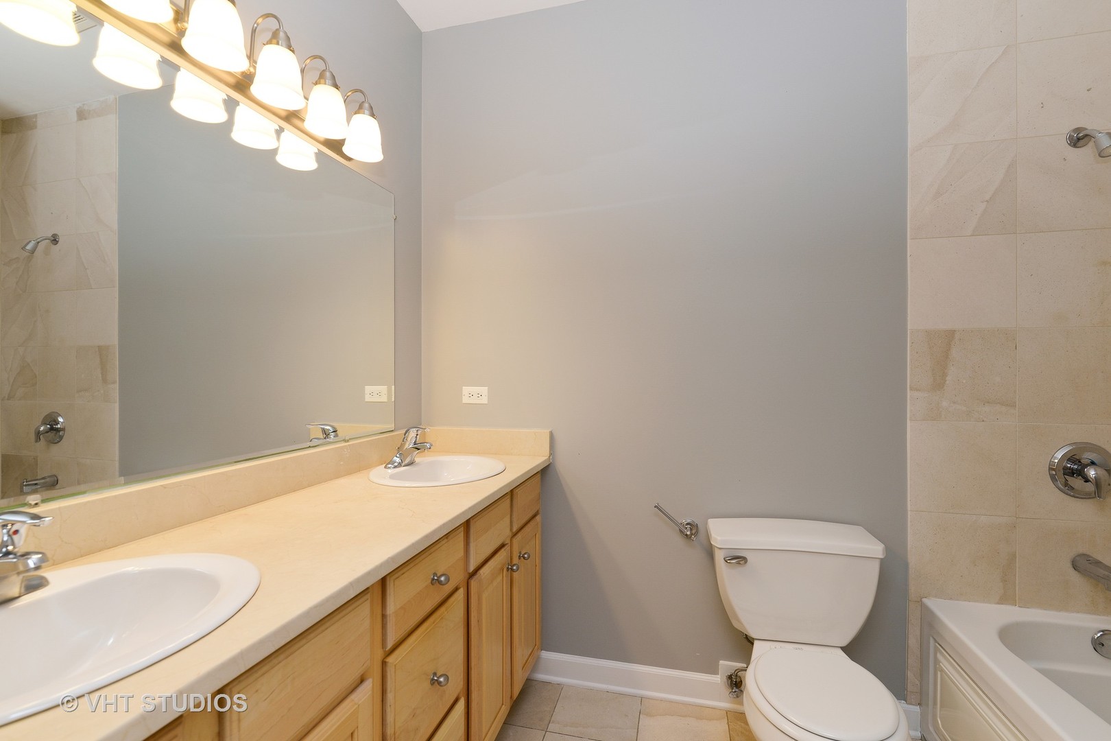 514 South Denvir Avenue, Unit 2 Chicago, IL 60612 - Photo 9 of 13 a bathroom with a toilet sink and mirror
