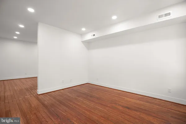 an empty room with wooden floor