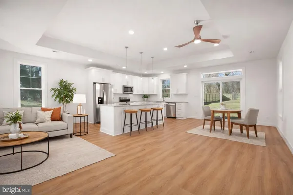 a living room with furniture and kitchen view