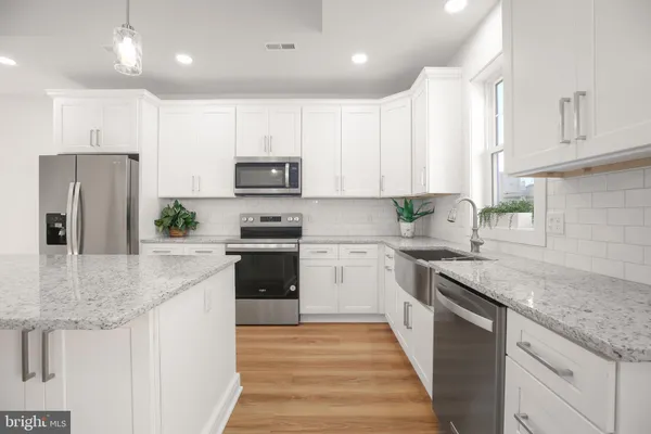 a bathroom with a sink a vanity and a large mirror