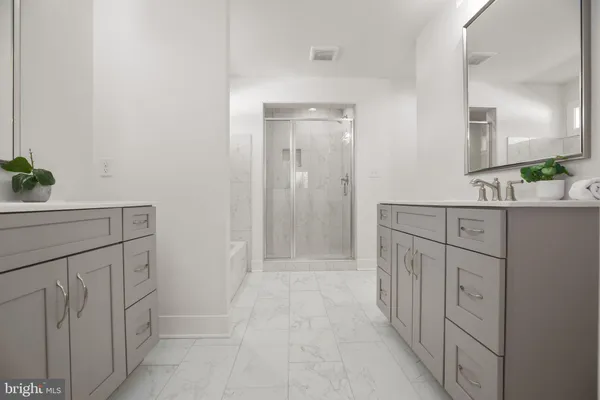 a bathroom with a shower sink and mirror