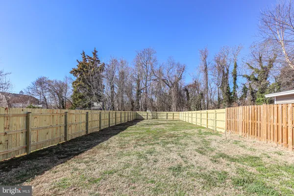 a view of a yard with a fence