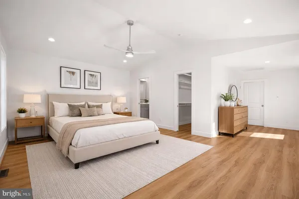 a spacious bedroom with a bed and a chandelier