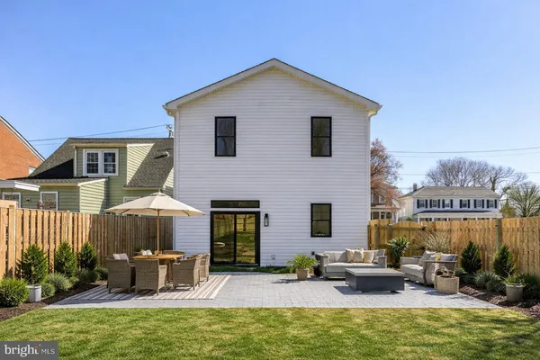 a view of a house with backyard sitting area and swimming pool