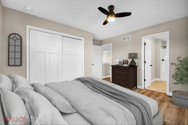 a bedroom with a bed and a chandelier
