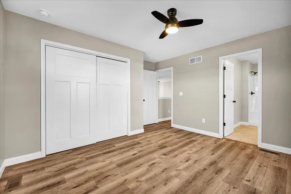 a view of empty room with ceiling fan