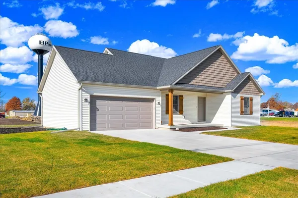 a view of a house with a yard and garage