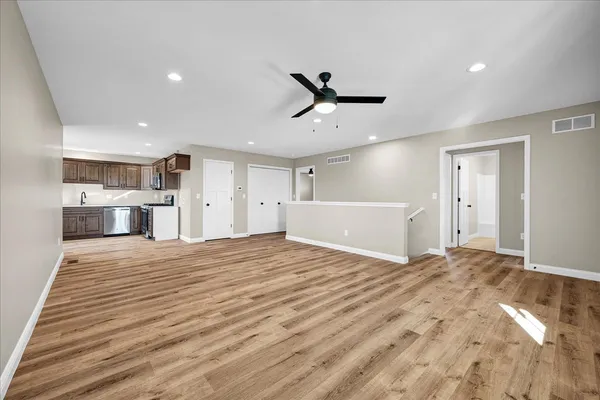 a large bedroom with a bed and a chandelier