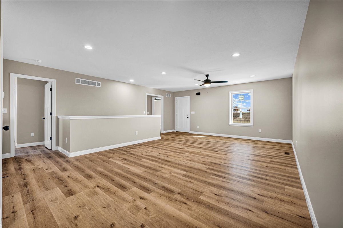 180 South Oak Street El Paso, IL 61738 - Photo 7 of 32 a view of an empty room with wooden floor and a window