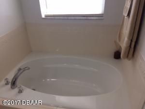 812 Star Reef Lane Edgewater, FL 32132 - Photo 12 of 17 a close up of a bathtub in a bathroom