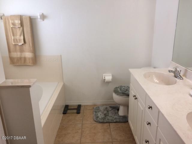812 Star Reef Lane Edgewater, FL 32132 - Photo 13 of 17 a bathroom with a sink toilet and mirror