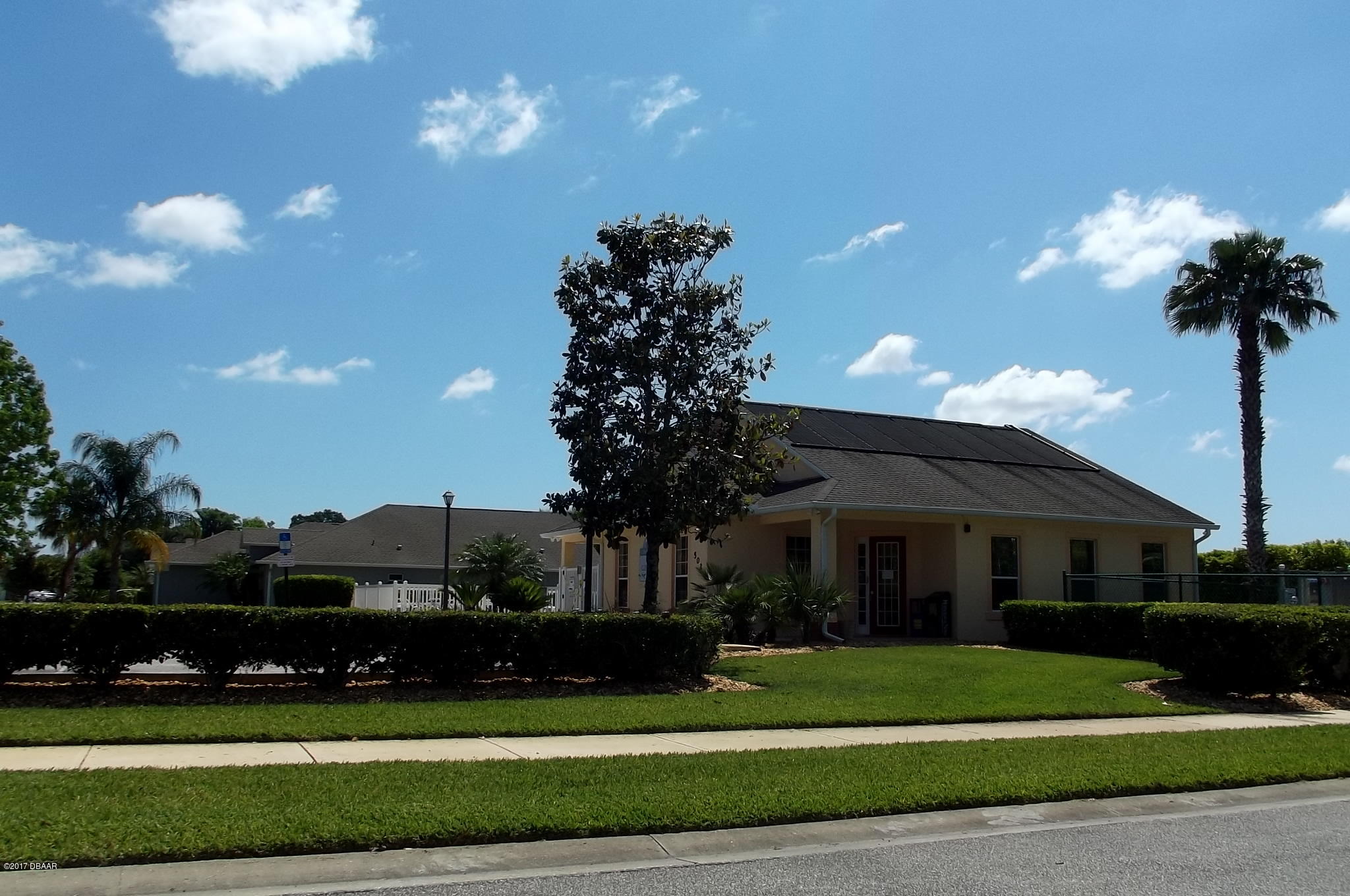 812 Star Reef Lane Edgewater, FL 32132 - Photo 17 of 17 a front view of a house with a yard and a garden
