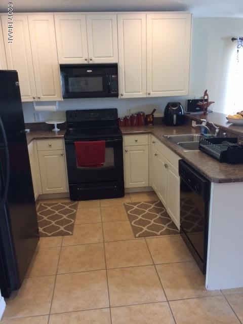 812 Star Reef Lane Edgewater, FL 32132 - Photo 3 of 17 a kitchen with a sink a stove and cabinets