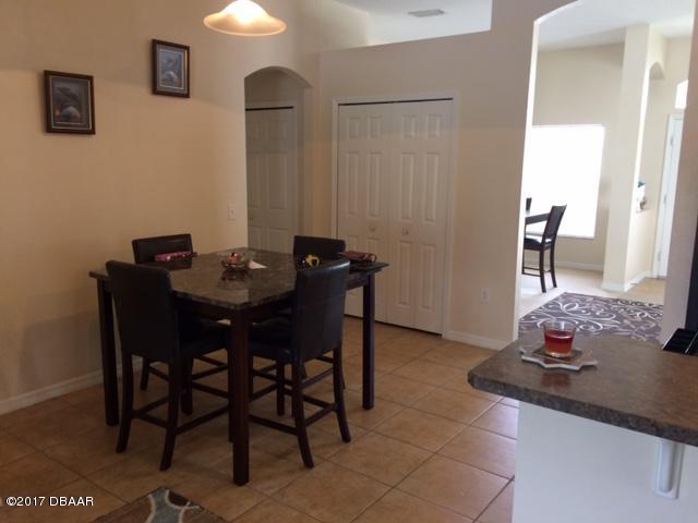 812 Star Reef Lane Edgewater, FL 32132 - Photo 5 of 17 a dining room with furniture and wooden floor