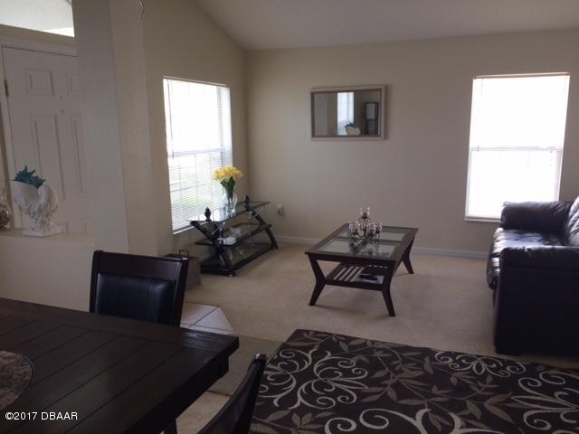 812 Star Reef Lane Edgewater, FL 32132 - Photo 7 of 17 a living room with furniture and a window