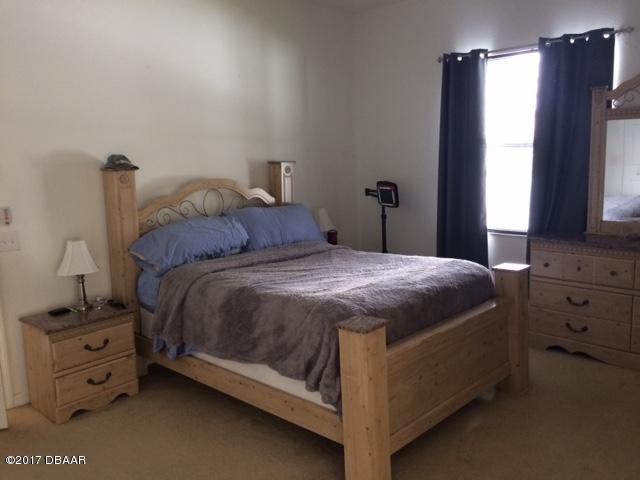 812 Star Reef Lane Edgewater, FL 32132 - Photo 9 of 17 a bedroom with a bed and a window