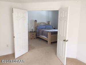 812 Star Reef Lane Edgewater, FL 32132 - Photo 10 of 17 a bedroom with a bed and a cabinets