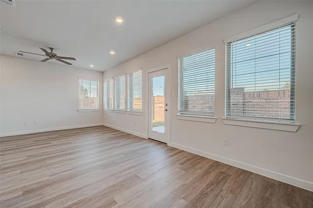 a large kitchen with a sink and dishwasher stove a refrigerator a sink with wooden cabinets