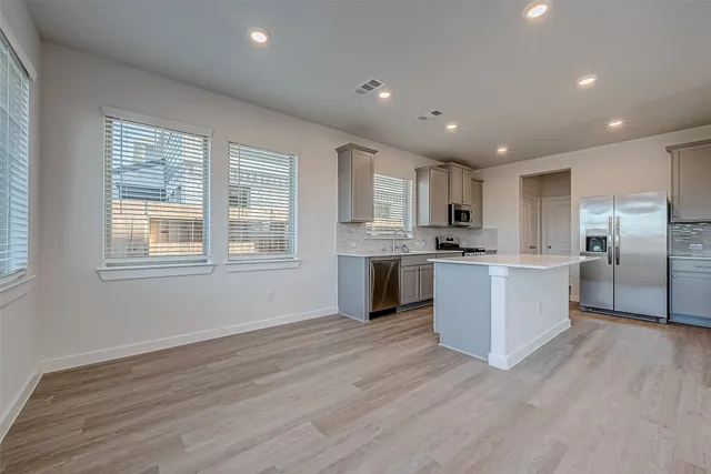 a view of kitchen and kitchen with sink wooden floor