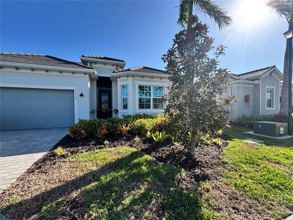 a view of a house with a garden and pathway