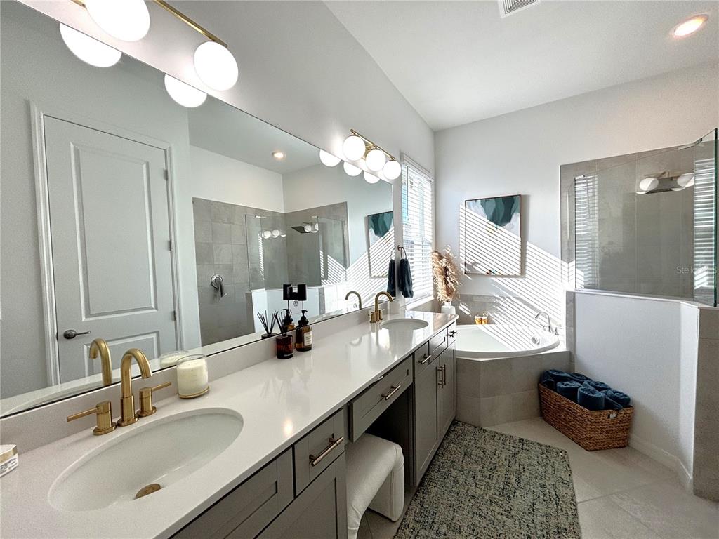 17510 Jadestone Court Venice, FL 34293 - Photo 13 of 46 a bathroom with a double vanity sink mirror and bathtub