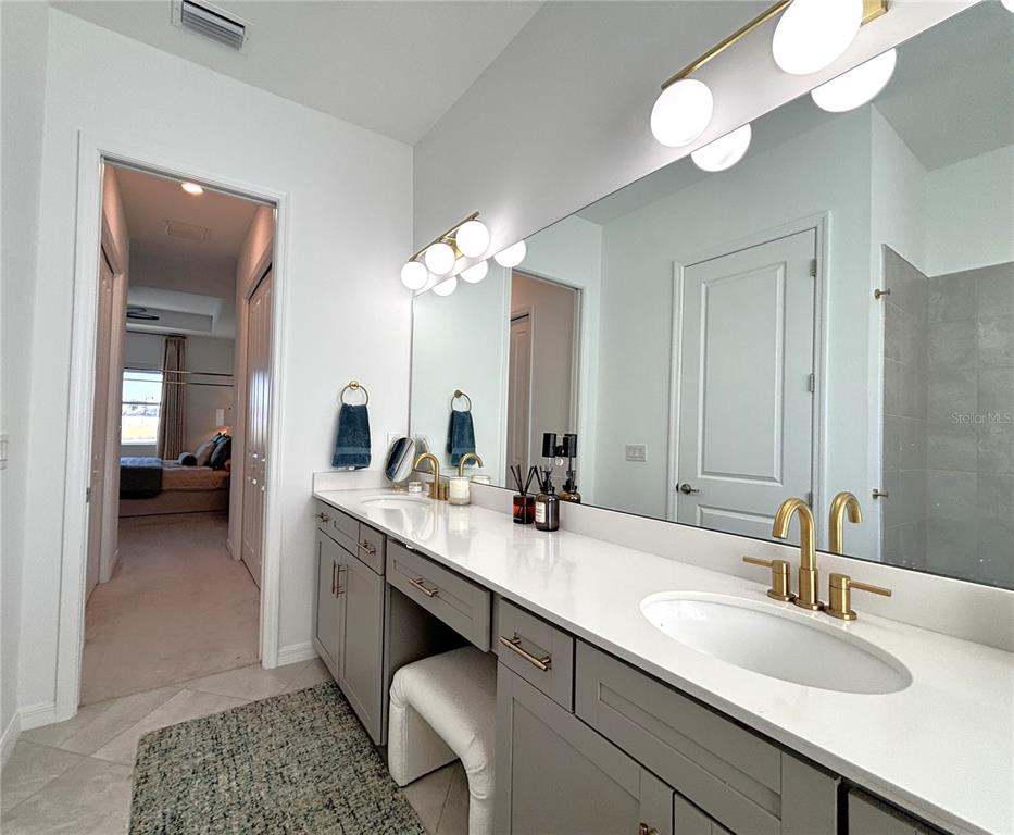 17510 Jadestone Court Venice, FL 34293 - Photo 15 of 46 a en suite bathroom with a double vanity sink and a mirror
