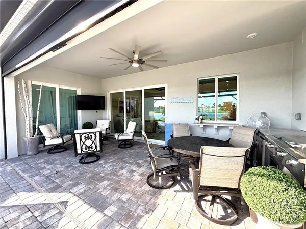 a living room with furniture large window and flat screen tv