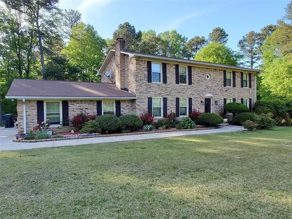 a front view of a house with swimming pool having outdoor seating