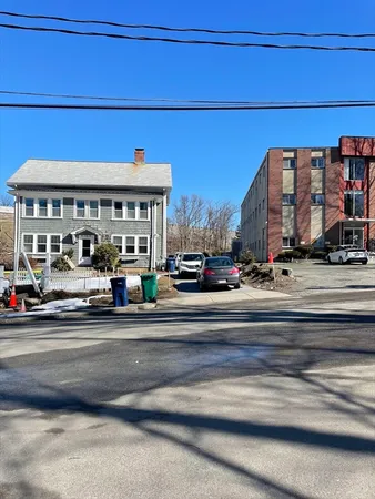 a view of a building and a car parked on the road