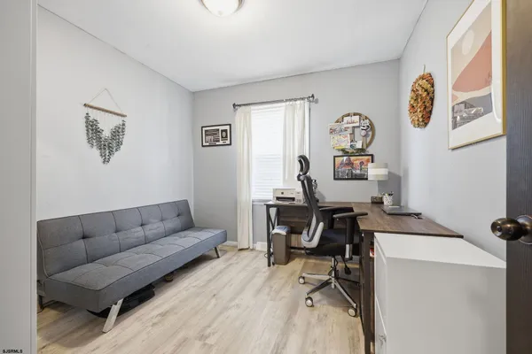 a view of a livingroom with workspace and a couch