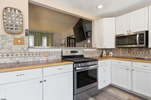 a kitchen with cabinets stainless steel appliances a sink and a stove top oven