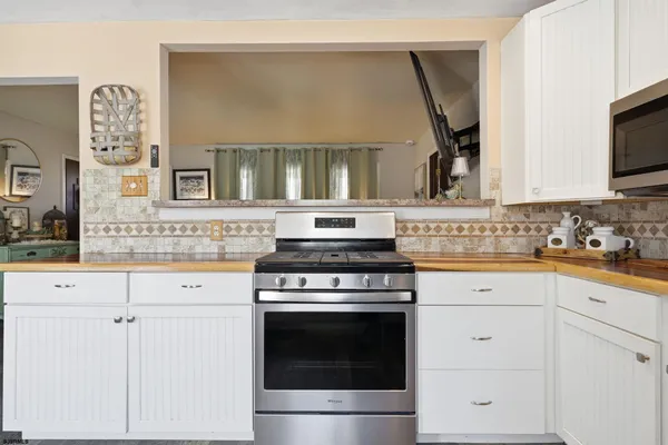 a kitchen with cabinets appliances and a sink