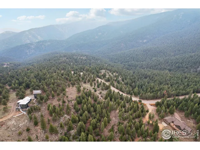 a view of a dry yard with mountains