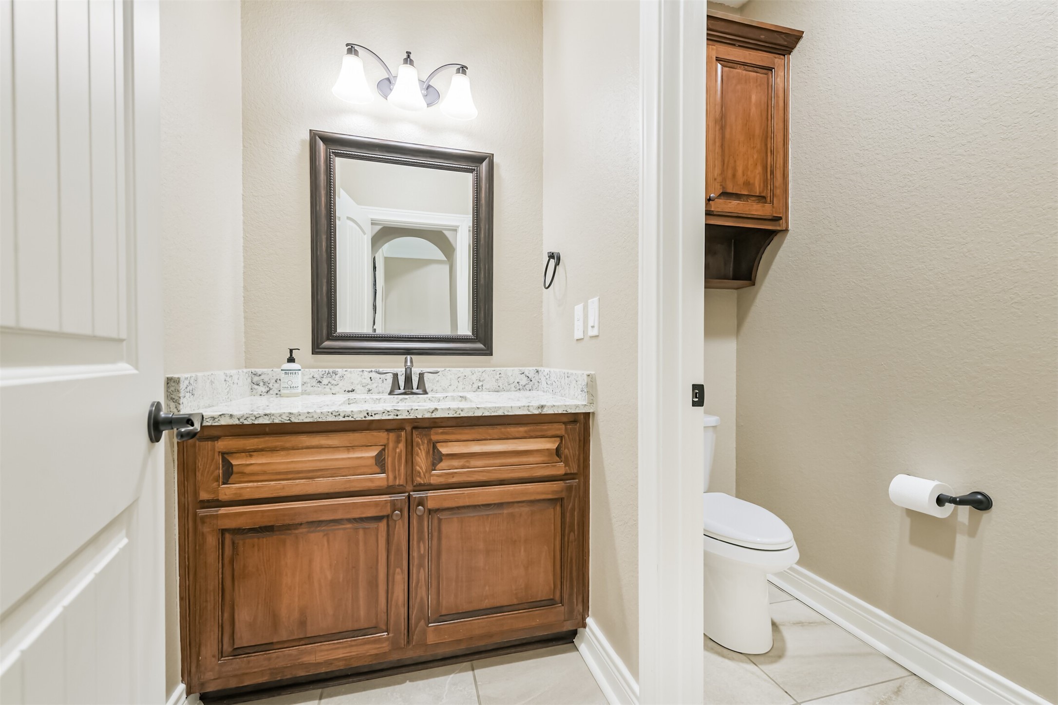 27553 Rio Blanco Drive Splendora, TX 77372 - Photo 15 of 41 a bathroom with a toilet sink and mirror