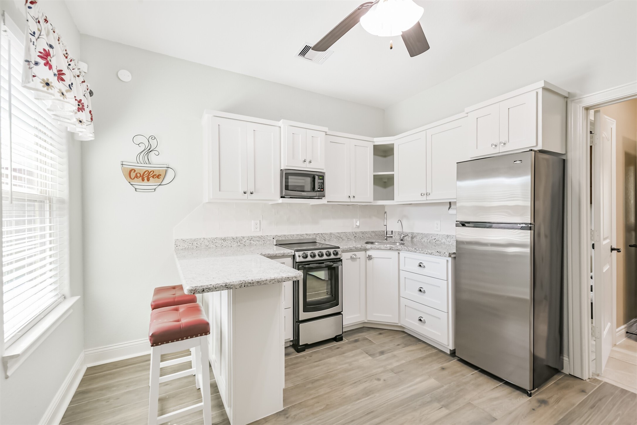 27553 Rio Blanco Drive Splendora, TX 77372 - Photo 17 of 41 a kitchen with cabinets stainless steel appliances and wooden floor