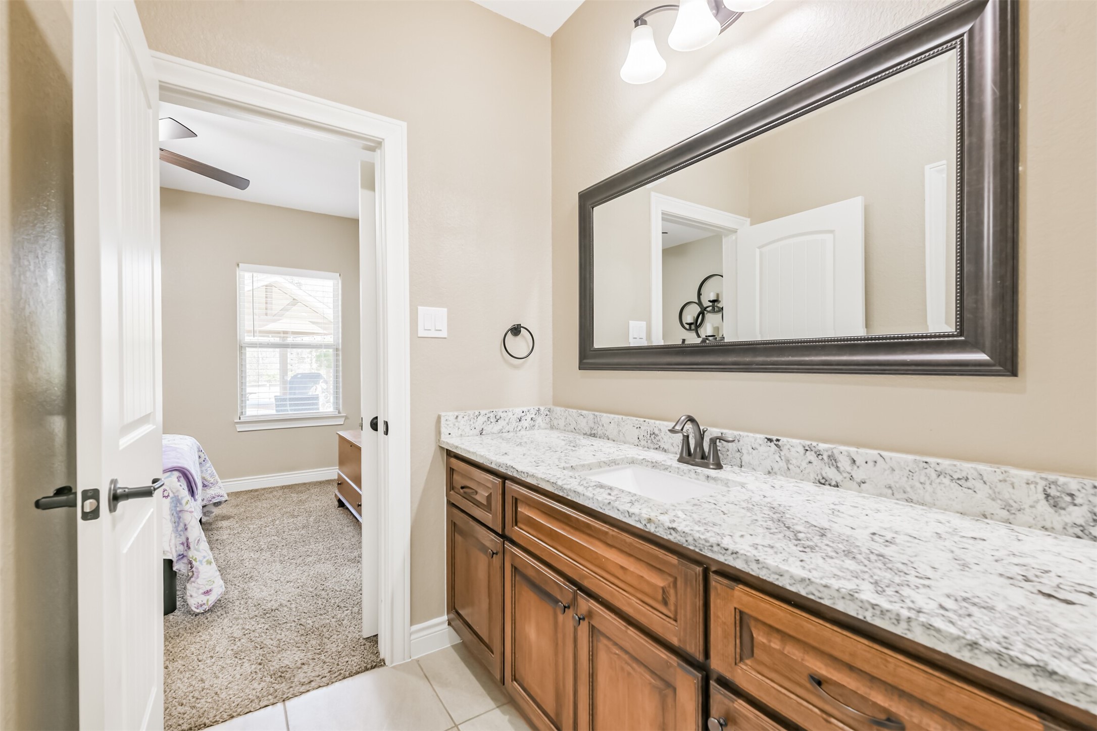 27553 Rio Blanco Drive Splendora, TX 77372 - Photo 18 of 41 a bathroom with a granite countertop sink mirror and