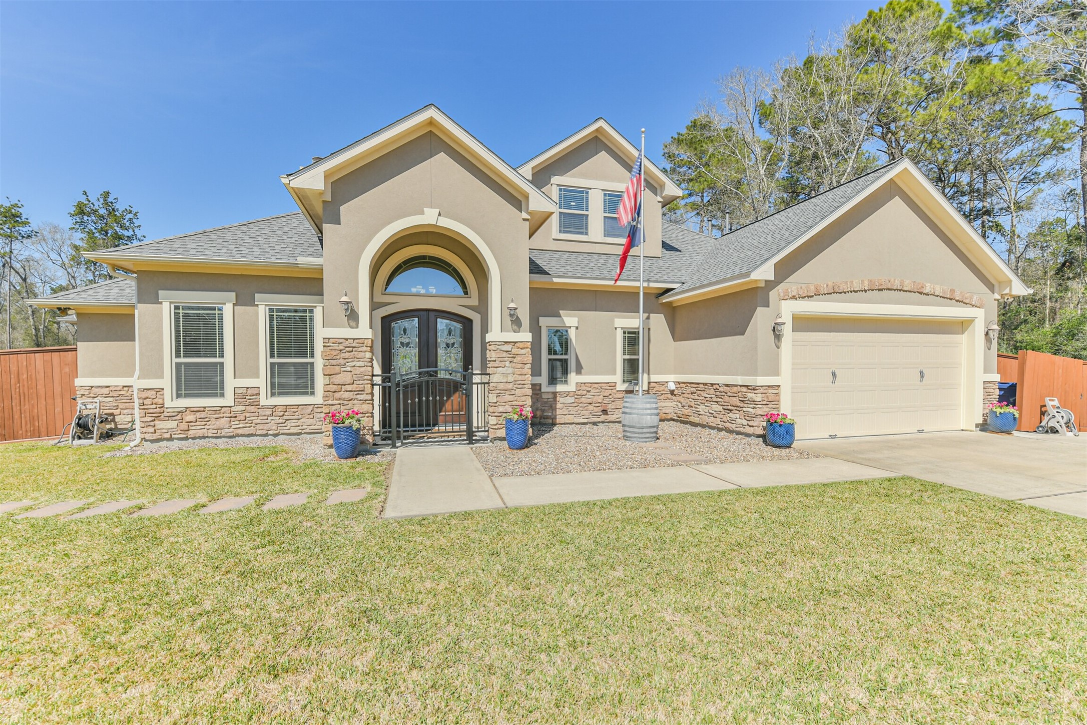 27553 Rio Blanco Drive Splendora, TX 77372 - Photo 2 of 41 a front view of a house with garden