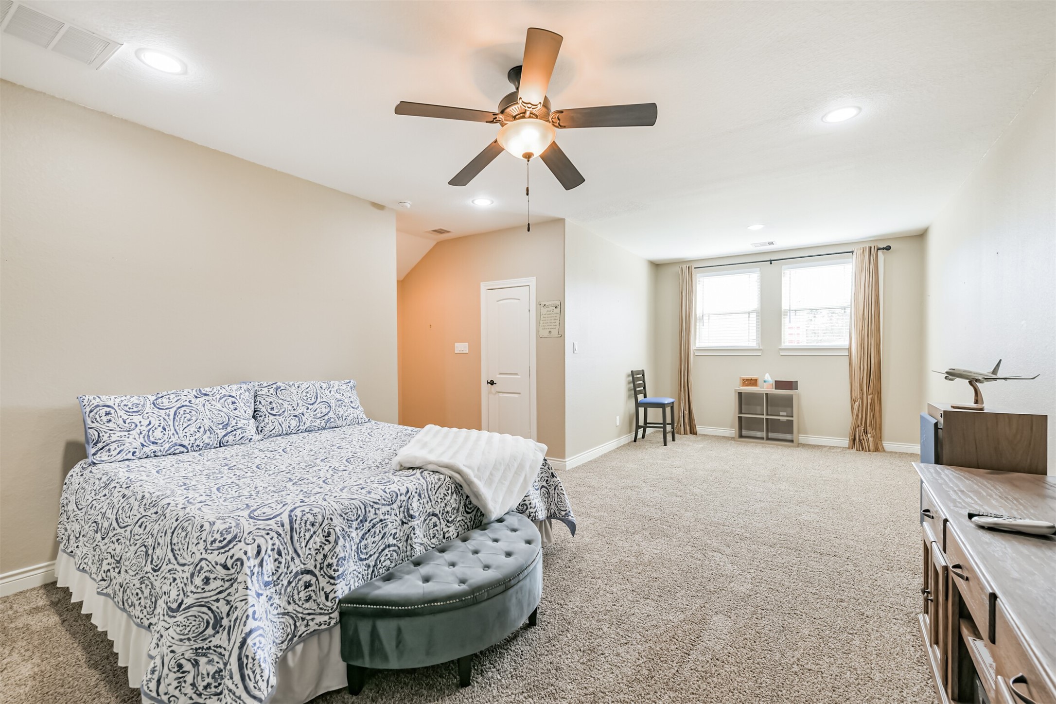 27553 Rio Blanco Drive Splendora, TX 77372 - Photo 23 of 41 a spacious bedroom with a bed and a chandelier