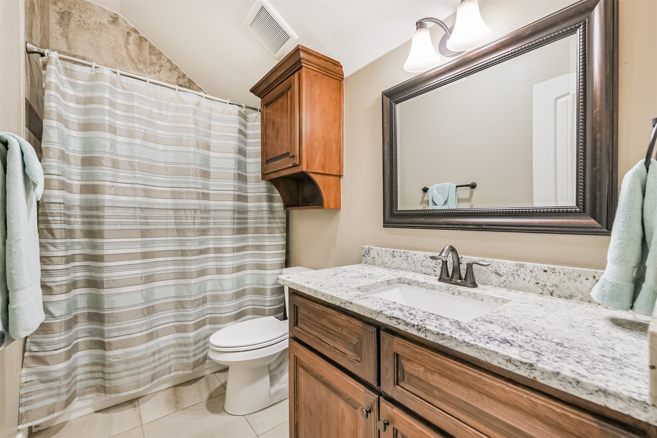 27553 Rio Blanco Drive Splendora, TX 77372 - Photo 24 of 41 a bathroom with a granite countertop toilet sink and mirror