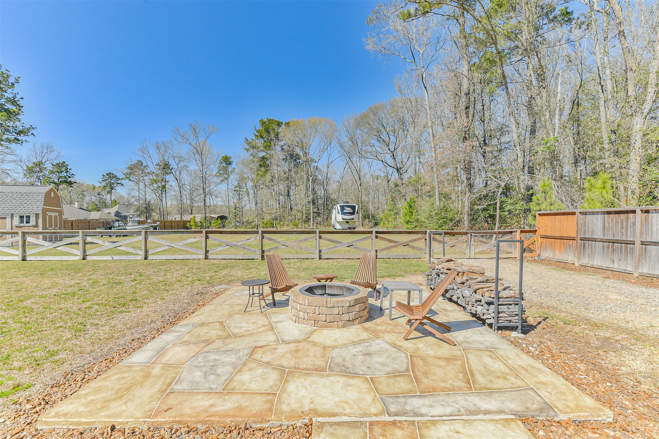 27553 Rio Blanco Drive Splendora, TX 77372 - Photo 35 of 41 a view of a swimming pool with a bench and trees in the background