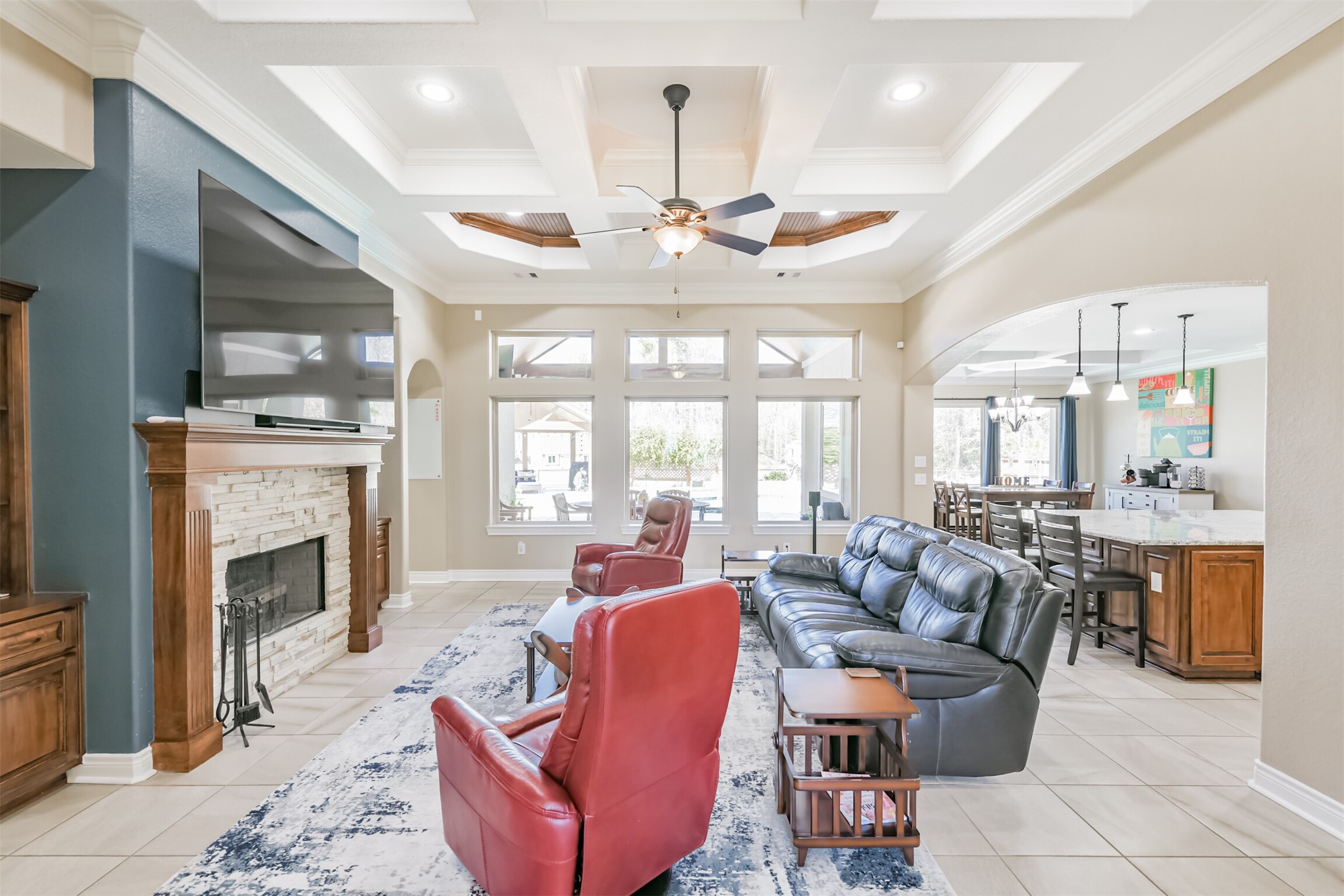 27553 Rio Blanco Drive Splendora, TX 77372 - Photo 6 of 41 a living room with furniture a fireplace and chandelier