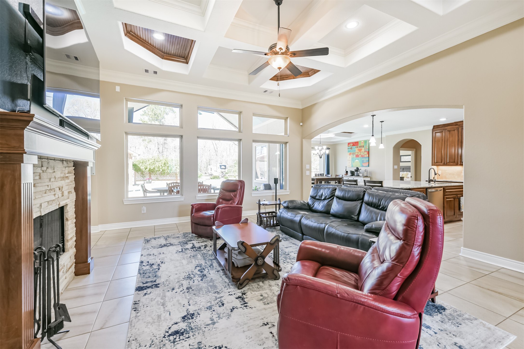 27553 Rio Blanco Drive Splendora, TX 77372 - Photo 7 of 41 a living room with furniture a fireplace and a chandelier