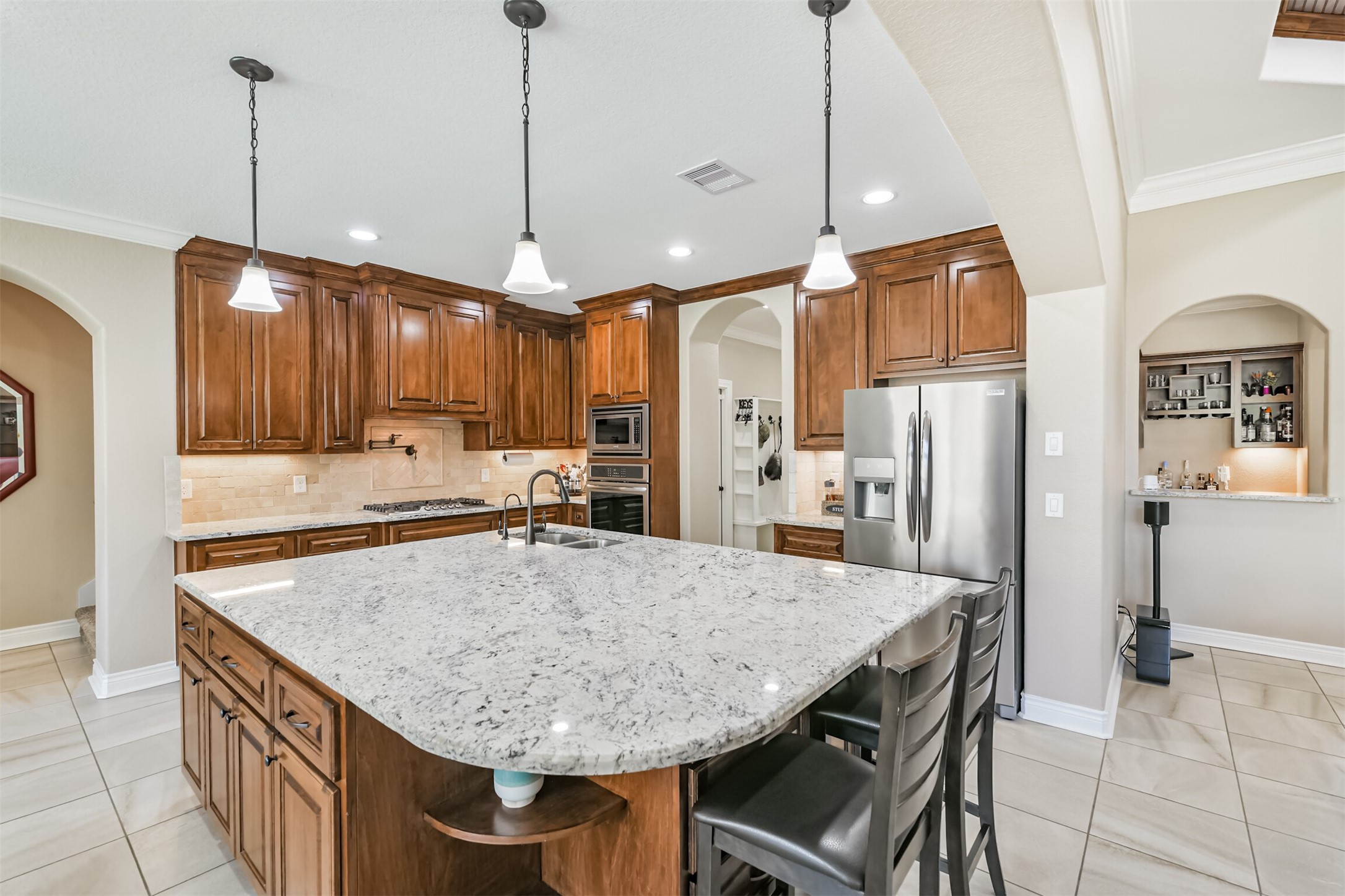 27553 Rio Blanco Drive Splendora, TX 77372 - Photo 8 of 41 a kitchen with stainless steel appliances granite countertop a sink refrigerator and cabinets