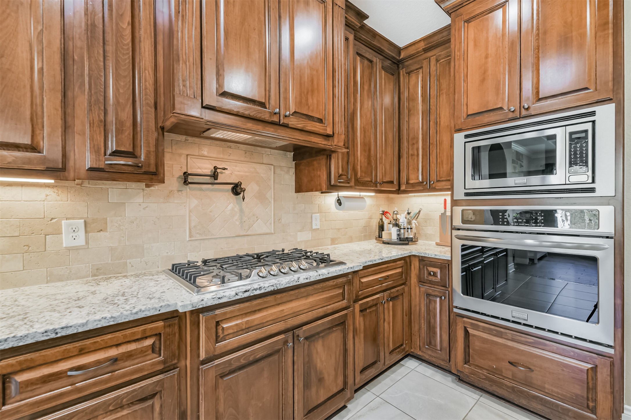 27553 Rio Blanco Drive Splendora, TX 77372 - Photo 10 of 41 a kitchen with granite countertop cabinets stainless steel appliances and a sink