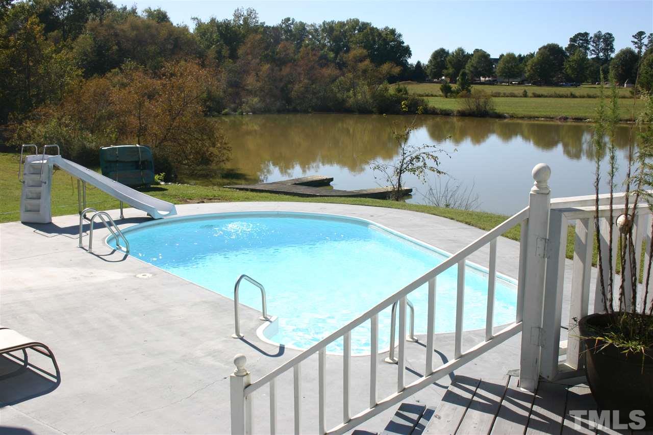 307 Bacon Road Rougemont, NC 27572 - Photo 20 of 25 a view of a swimming pool with seating area and lake view