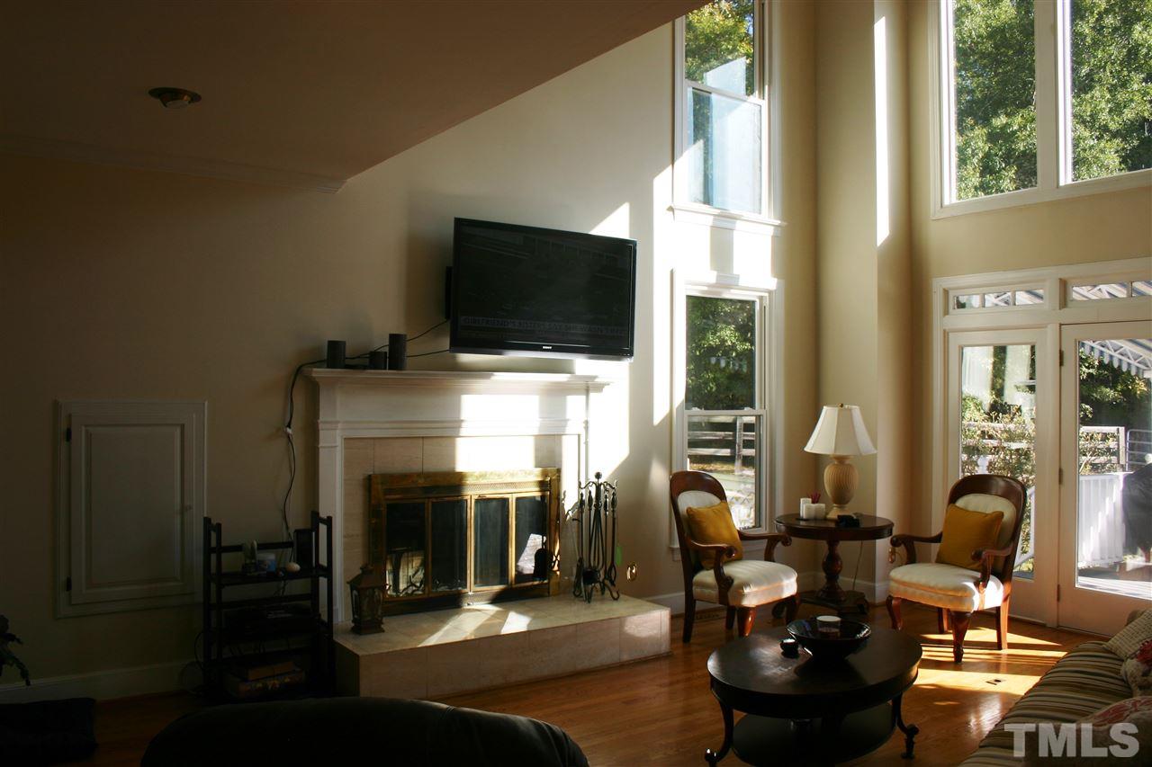 307 Bacon Road Rougemont, NC 27572 - Photo 4 of 25 a living room with furniture a fireplace and a flat screen tv
