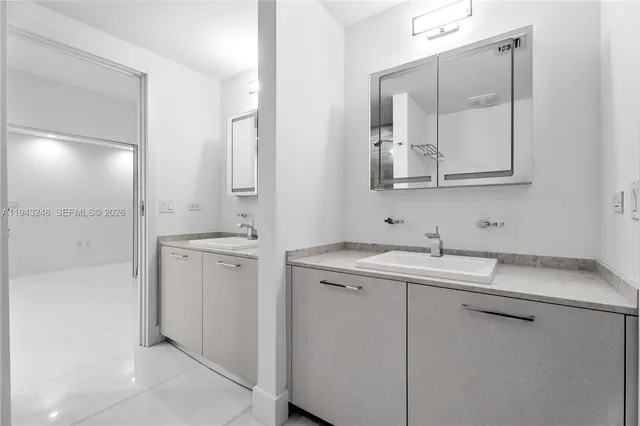 a bathroom with a double vanity sink mirror and