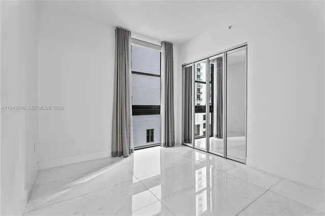 a large white room with entrance and door